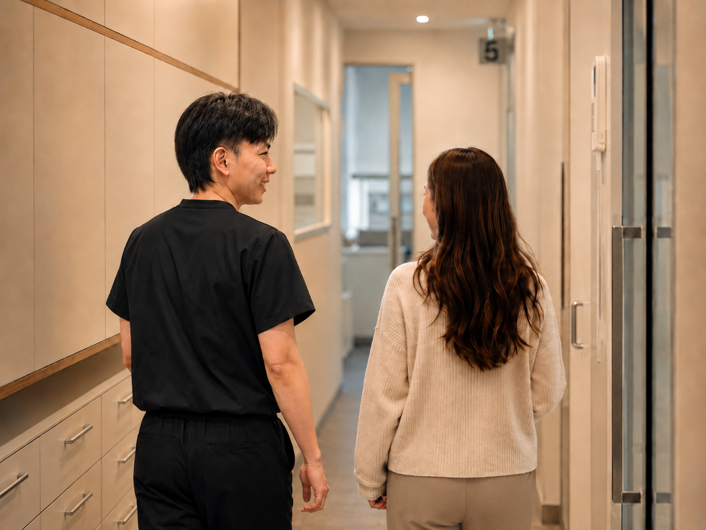 Dr Justin Lee walking a patient out to reception at Pacific Smiles Dental Belconnen